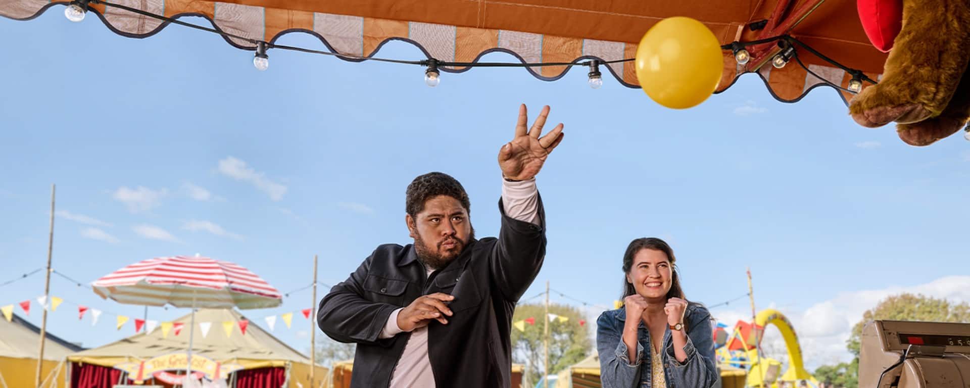 ASB &lsquo;Small steps&rsquo; campaign: a fairground scene with two people reaching for a yellow balloon